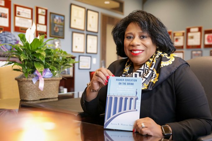 Dr. Harvey-Smith posing with her new book release "Higher Education on the Brink: Reimagining Strategic Enrollment Management in Colleges and Universities"