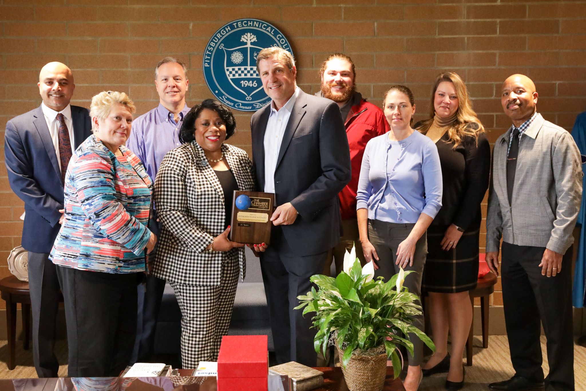 A group photo of Dr. Harvey-Smith, Rodney Clark, Sunjay Bali and PGH Airport Chamber posing with the 25 Year Membership plaque.