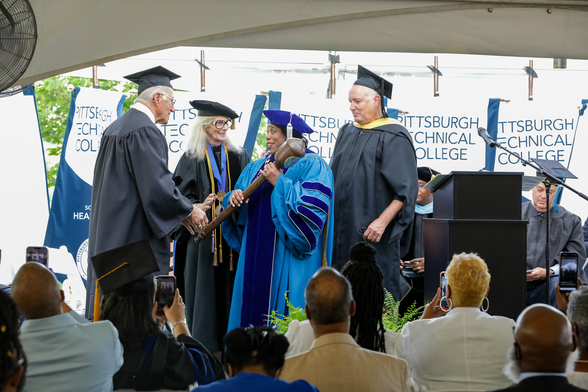 Dr. Harvey-Smith receiving the mac at the Installation Ceremony.