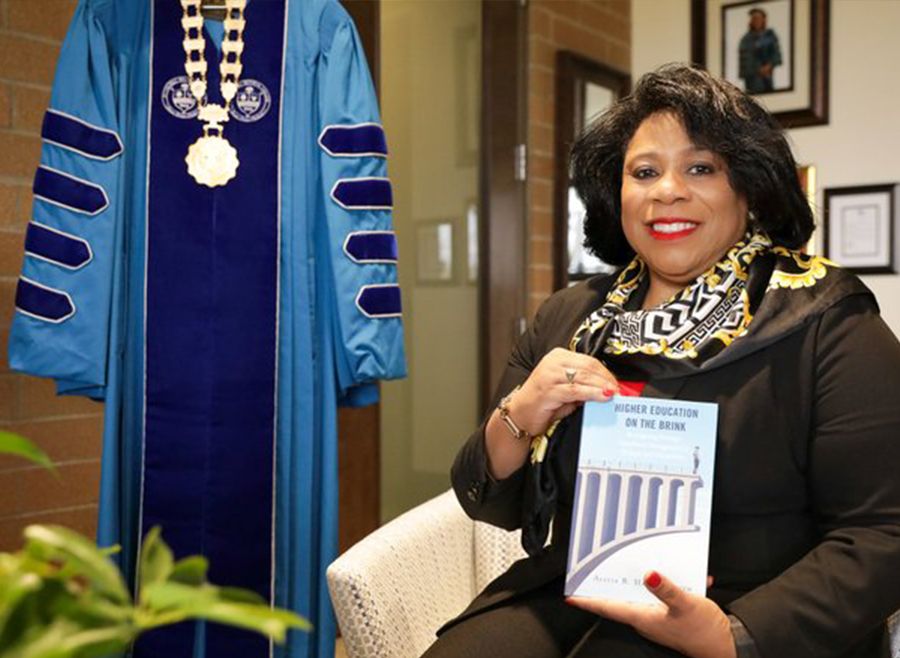 A photo of Dr. Harvey-Smith holding her book.