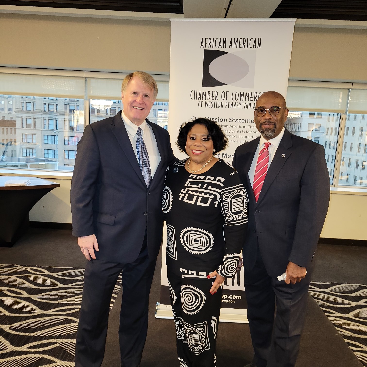 Dr. Alicia B. Harvey-Smith, Quintin Bullock, and Rich Fitzgerald posing together for a picture at the African American Chamber of Commerce breakfast.