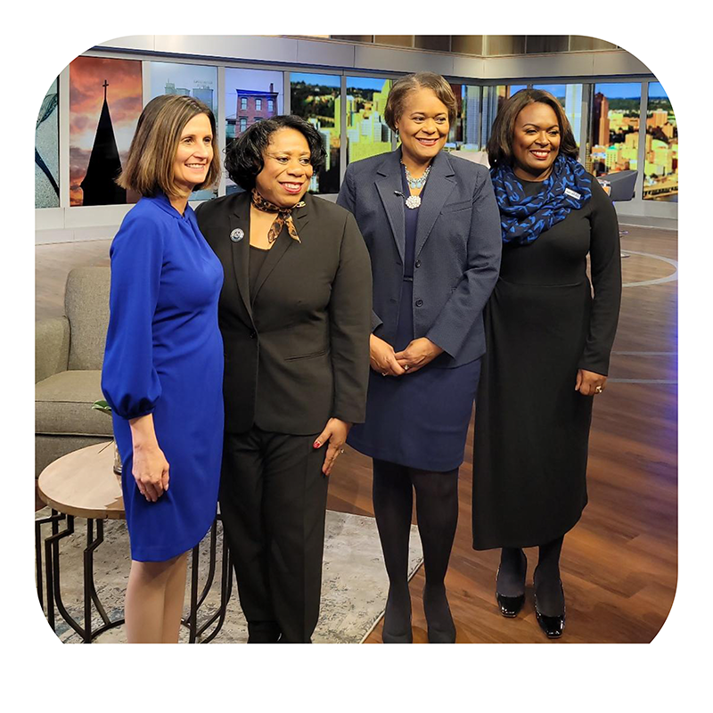 Dr. Alicia Harvey-Smith posing in a group photo with several other leading ladies on KDKA's Intersection.