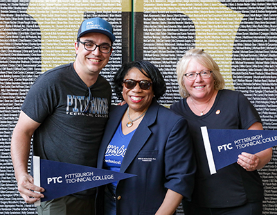 Dr. Harvey-Smith, Ethan Mansberger, and Christine Ioli and standing together for a photo at the PNC Park Alumni Night.