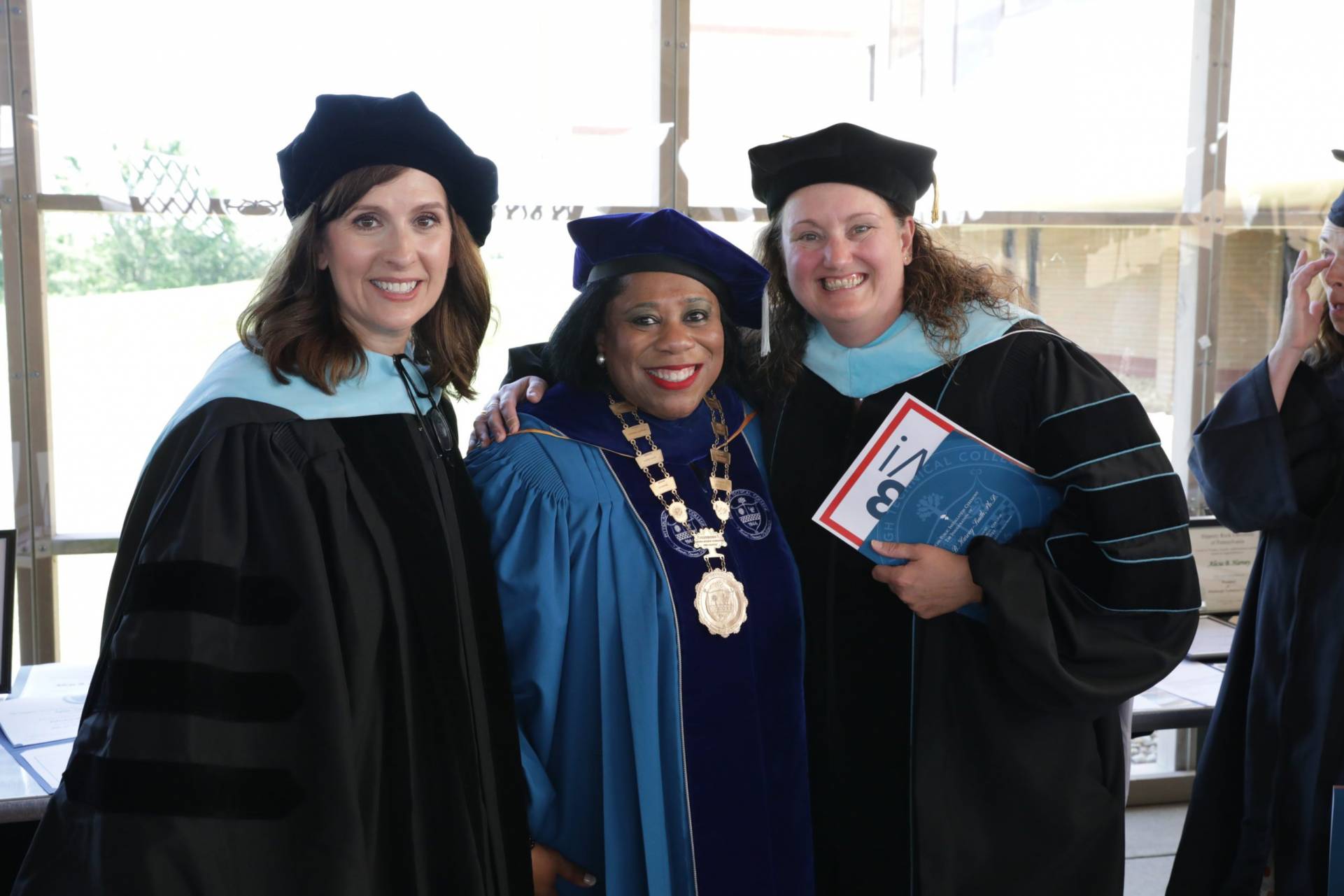 A photo of Dr. Harvey-Smith posing with a guest from the Installation Ceremony.