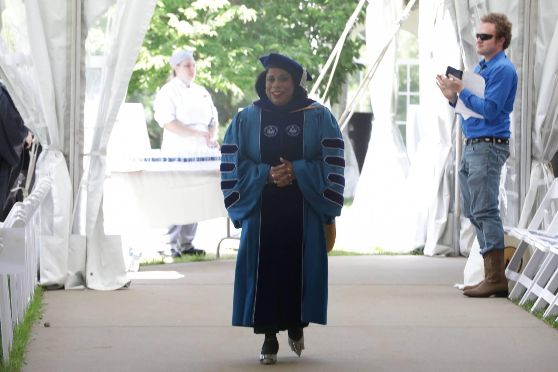 Dr. Harvey-Smith walking alone following the procession for the Installation Ceremony.